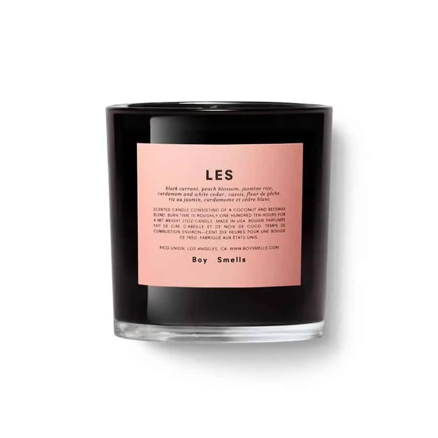 Boy Smells candle in a black glass with a pink label