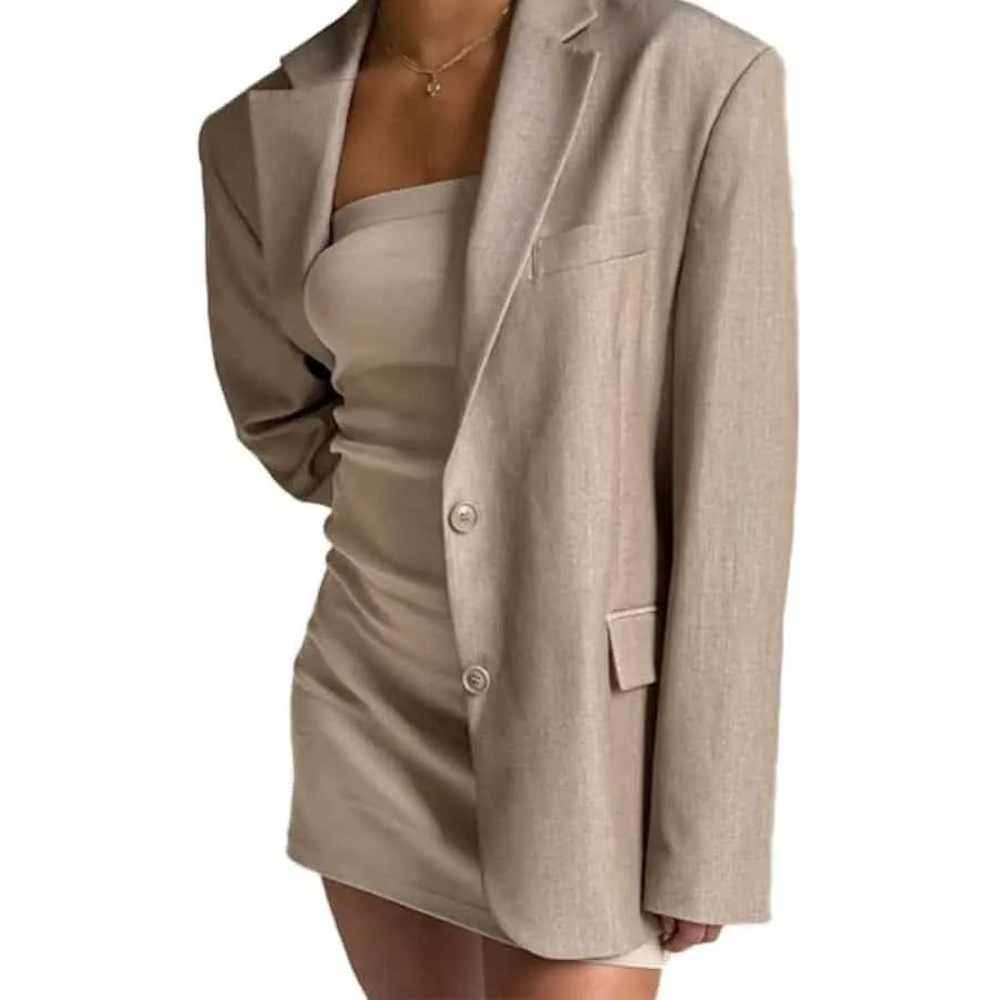 Model in an oat-colored oversized Djerf Avenue blazer