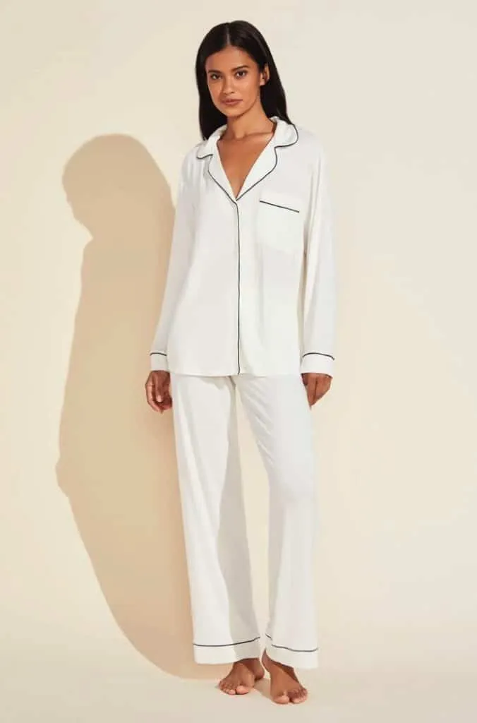 Model in an ivory Eberjey long pajama set with navy piping