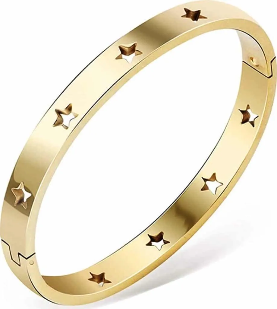 Open gold bangle bracelet with small star cutouts around the band
