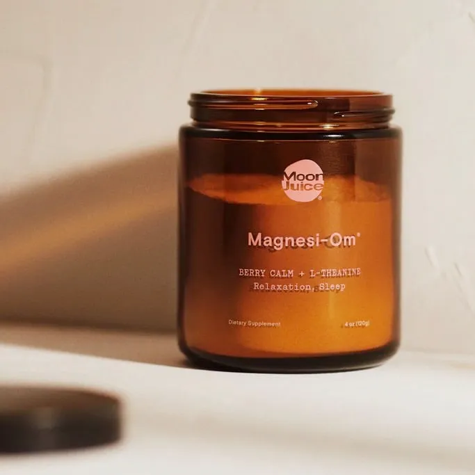 Open amber jar of Moon Juice Magnesi-Om berry calm powder for relaxation and sleep