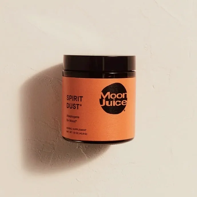 Jar of Moon Juice Spirit Dust adaptogens for mood on a textured off-white background
