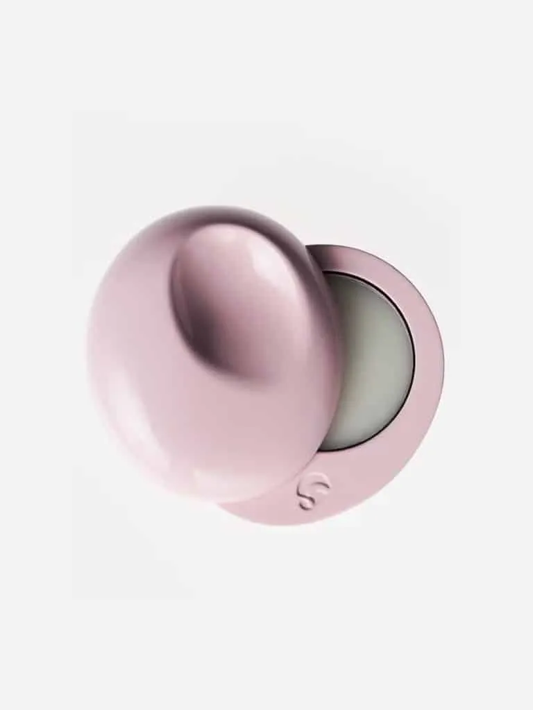 Glossier You solid perfume in a pink pebble-shaped compact, opened