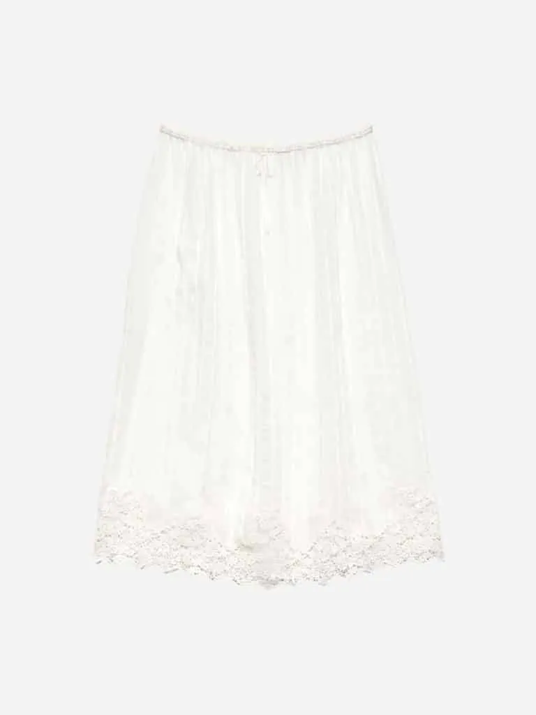 DÔEN Albina Skirt in Salt: a long white linen skirt with a lace hem