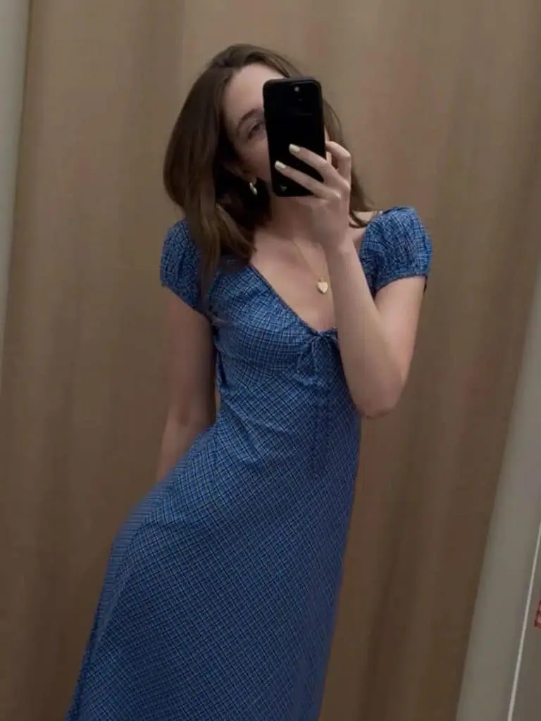 Mirror selfie of a woman in a blue DÔEN Sofia puff-sleeve midi dress