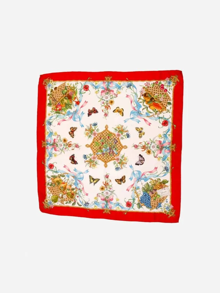 Gucci silk scarf with a red border, fruit baskets, flowers, ribbons and butterflies on a white field