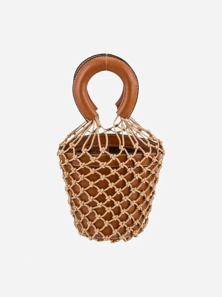 Cognac leather Staud bucket bag wrapped in tan macramé netting with a round padded handle