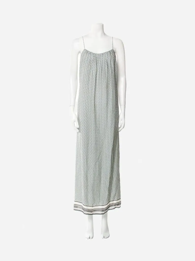 Vince silk maxi dress with a small teal geometric print and striped hem on a white mannequin
