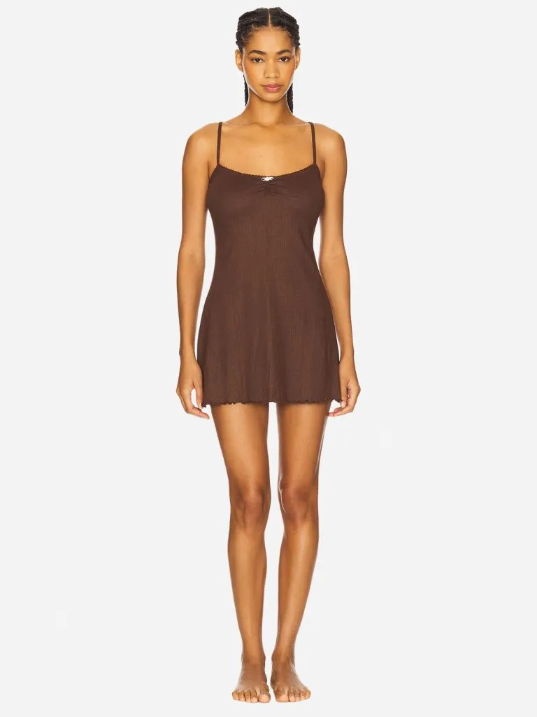 Model in a short brown slip dress with thin straps