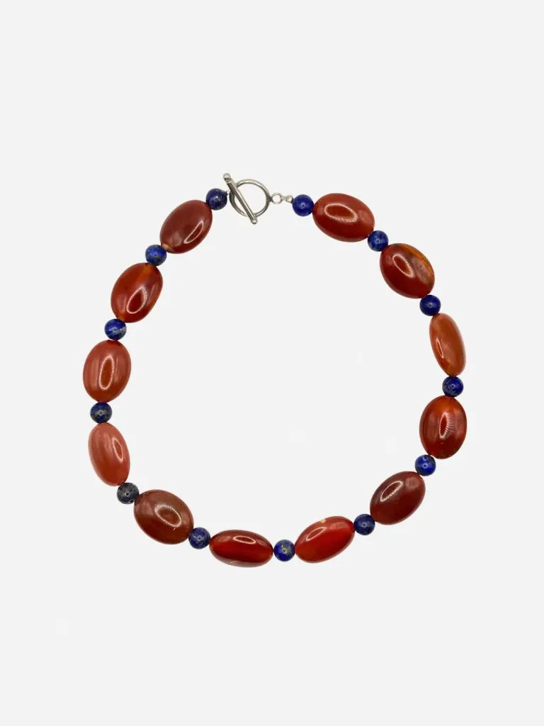Lemon Lua Venus Carnelian necklace with orange carnelian and small blue beads and a silver toggle clasp