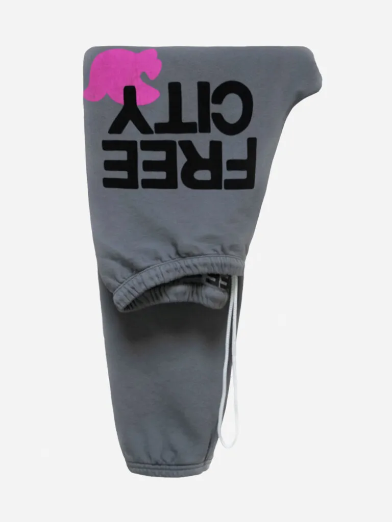 Folded heather grey FREECITY sweatpants with a hot pink dove logo and black FREE CITY lettering