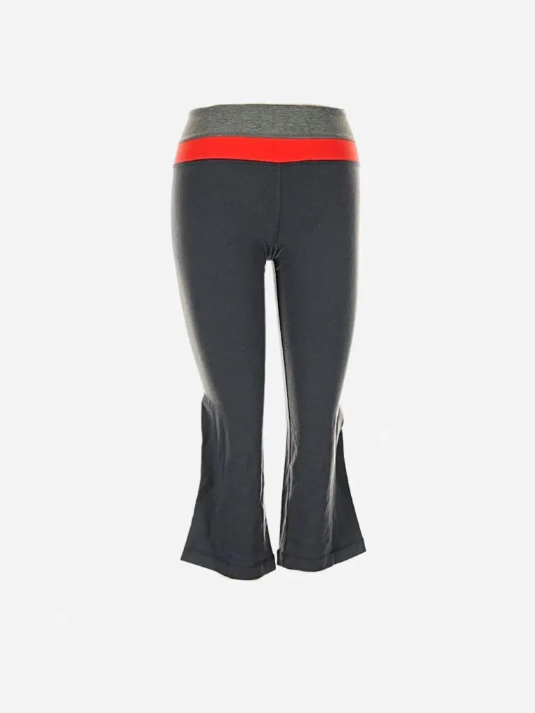 Dark charcoal flared Lululemon capri pants with a heather grey and red color-blocked waistband